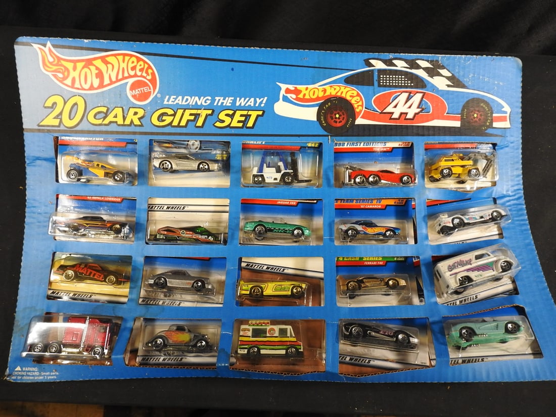 Hot Wheels 20-Car Gift Sets, 1995 and 1999, Lot of 2: Two boxed Hot Wheels 20-Car Gift Sets identified as 1995 and 1999 issues. Assorted die-cast cars and trucks are visible in each package.