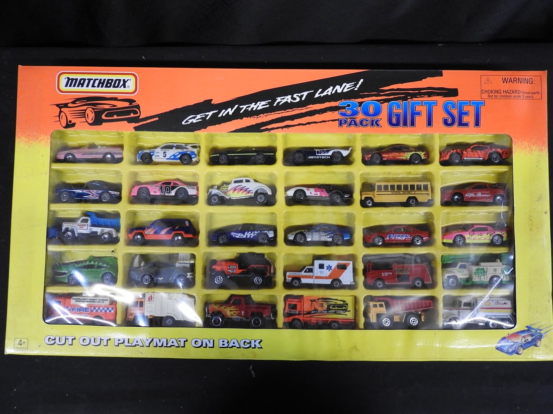 1995 Matchbox 30-Pack Gift Set: Boxed 1995 Matchbox 30-Pack Gift Set with assorted die-cast vehicles and a cut-out playmat printed on the reverse.
