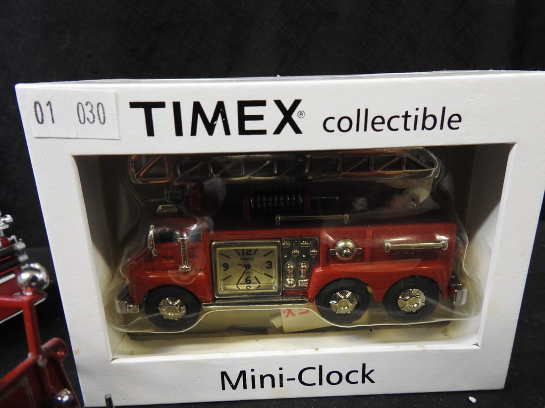 Timex Fire Truck Mini-Clock and Model Fire Engines, Lot of 6: Collection comprising a boxed Timex fire truck mini-clock and five detailed model fire engines. Visible examples include Corgi American LaFrance and Mack fire apparatus.