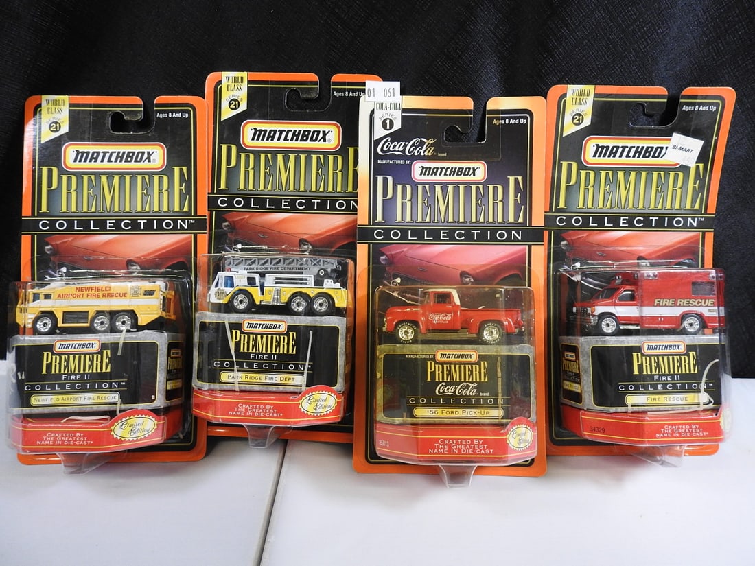 Matchbox Premiere Fire and Coca-Cola Vehicles, Lot of 4: Four carded Matchbox Premiere Collection models: Newfield Airport Fire Rescue, Park Ridge Fire Department, Coca-Cola 1956 Ford Pickup and Fire Rescue vehicle.