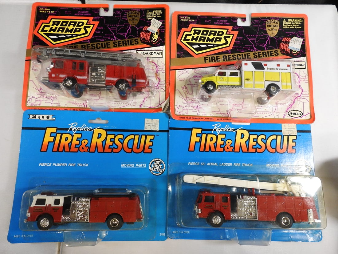 Road Champs and ERTL 1:64 Fire Trucks, Lot of 4: Four packaged 1:64-scale fire trucks: two Road Champs Fire Rescue Series vehicles and two ERTL Replica Fire & Rescue Pierce trucks, including pumper and aerial ladder apparatus.