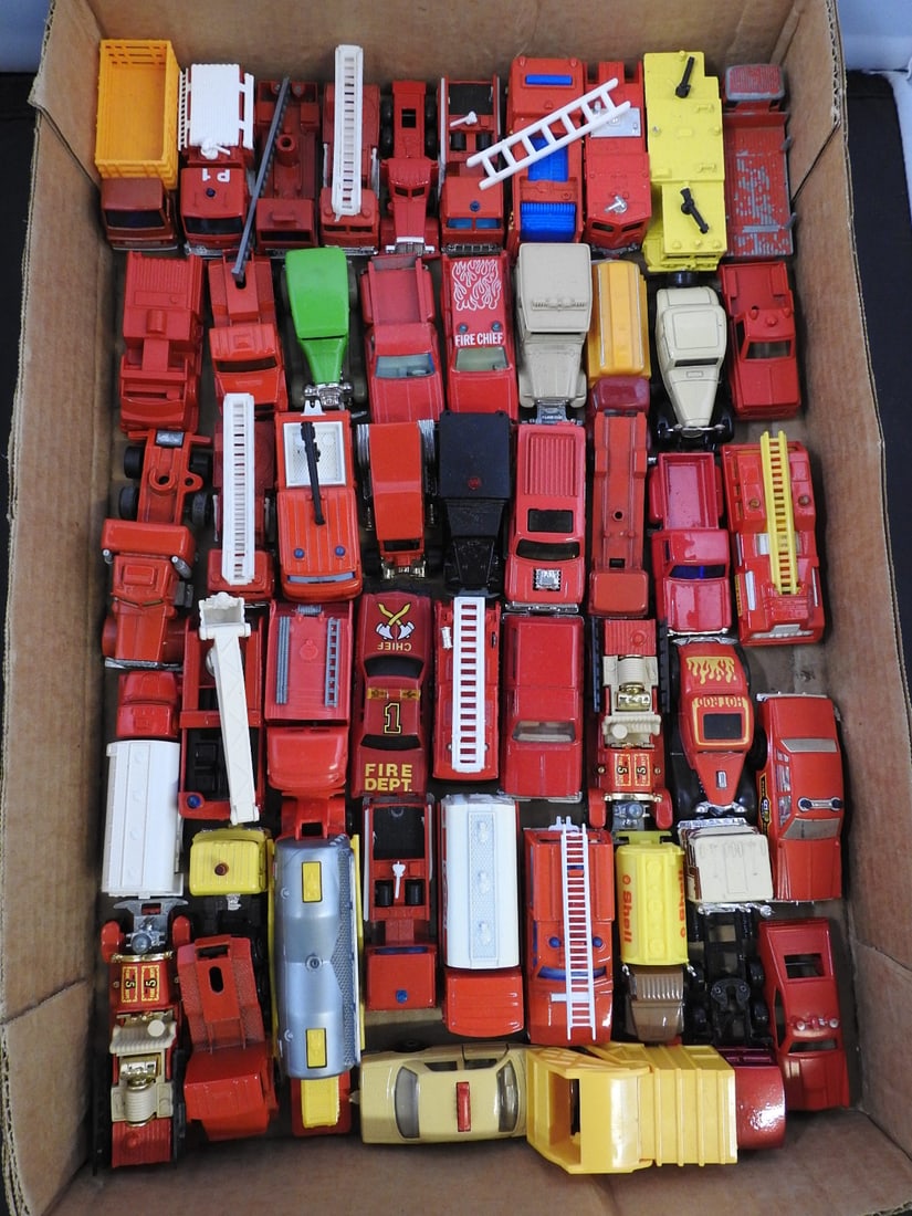 Large Loose Fire Truck and Service Vehicle Lot: Large loose assortment of primarily red fire apparatus and service vehicles, including ladder trucks, pumpers, tankers, vans and pickups.
