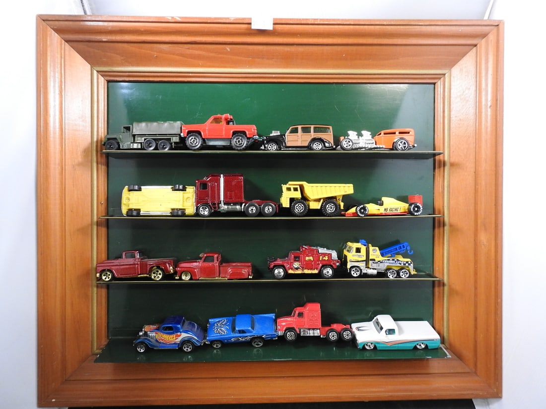 Wood-Framed Display Case with Die-Cast Vehicles: Wood-framed wall display case with glass shelves holding approximately 20 loose die-cast cars, trucks and racing vehicles. Two metal shelf-trim pieces are loose.