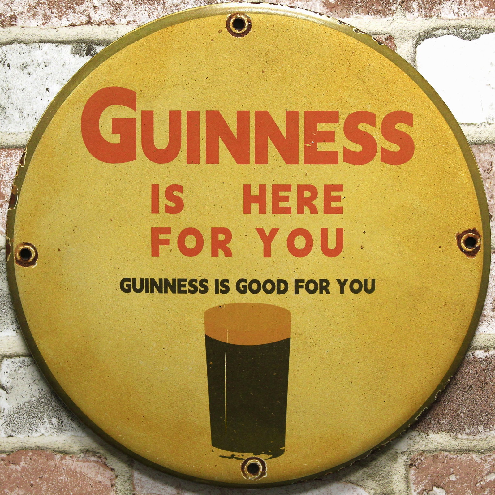 Guinness Is Here For You Beer 12-Inch Porcelain Enamel Sign Reproduction: 12-inch Guinness Is Here For You Beer porcelain enamel advertising sign; handcrafted vintage-style reproduction. A dark pint illustration sits beneath Guinness Is Here For You and Guinness Is Good For