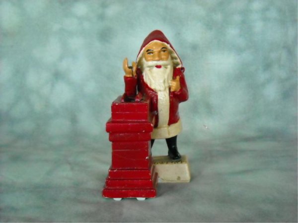 Cast Iron Santa And Chimney Bank: This is a 1960's reproduction. It has been repainted. Working condition is unknown. The important thing about this bank is that it was made by John Wright. and part of, "The Book Of Knowledge Collecti