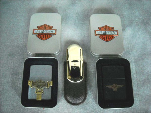 Zippo Lighters Harley Davidson: a,b.Two Harley Davidson lighters with tin boxes c.Marlboro lighter with leather pouch.