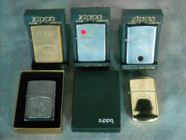 Lot of Zippo Lighters Plus: a.Camel gold in color with engraving "BVM" b.Camel silver in color with a picture of camel on motorcycle. c,d.Two Zippos e.Camel gold in color.
