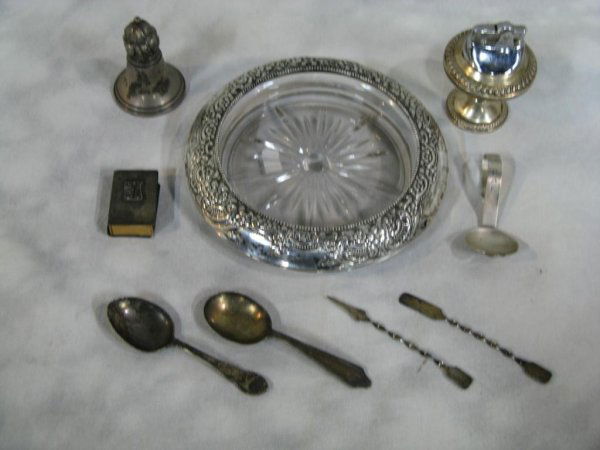 Sterling Silver Lot Frank M. White: Lot contains (9) pieces of sterling silver including ornate cutglass and sterling champaigne bottle coaster, (3)baby spoons (2)appetizer picks (1)match box cover (2)cigarette lighters