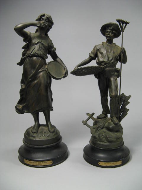 Pair Of French Bronze Patinated Garnitures: With French titles as follows; "Chanteur Des Rues Par L.F. Moreau" and "Moissoneur Par C. Desmeure". Female h. 15.5", Male h. 14.5".