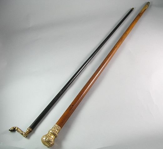 Lot Of Two Canes Repousse & Horses Hoof: One with a gold-plated ornate top with repousse floral and scroll decoration, monogrammed, 35 3/4" length, some dents. Second cane is ebony topped with a gold plated shoed horse hoof and leg, hoof mar