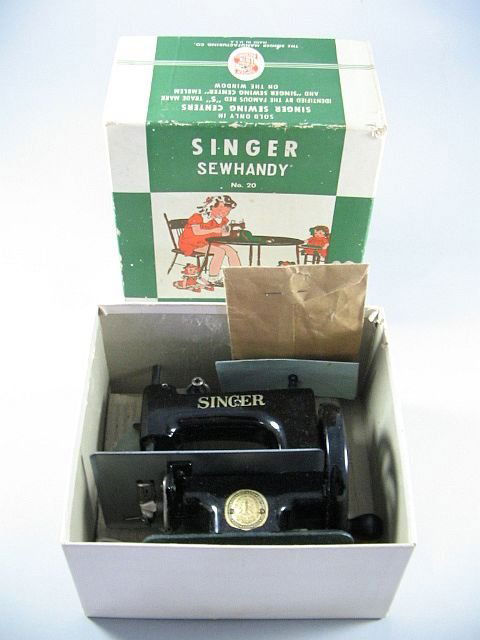 A Toy Singer Sewing Machine: As found in original box with paper work, h.6.5" x w.6".