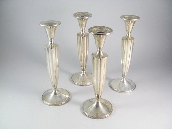 4 Weighted Sterling Silver Candlesticks: Reeded tapered form, stamped G within penguin #219, h.9 3/4". 15.09ozt, in as found condition, one candlestick has a dent.