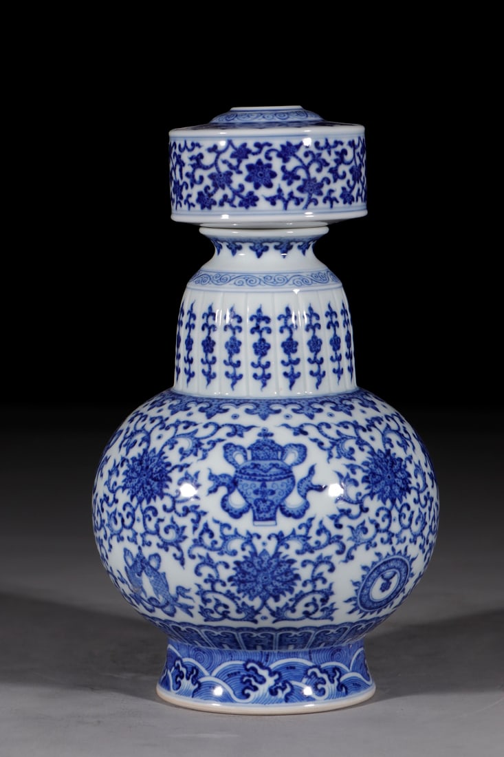 An Exquisite Chinese Blue and white porcelain vase with lotus scroll and eight treasures design: Size: Height 27 cm - Width 14.2 cm |Materials: Porcelain |Style Dynasty: Qing dynasty |Inscription: Qianlong Mark |Object: Chinese Antique