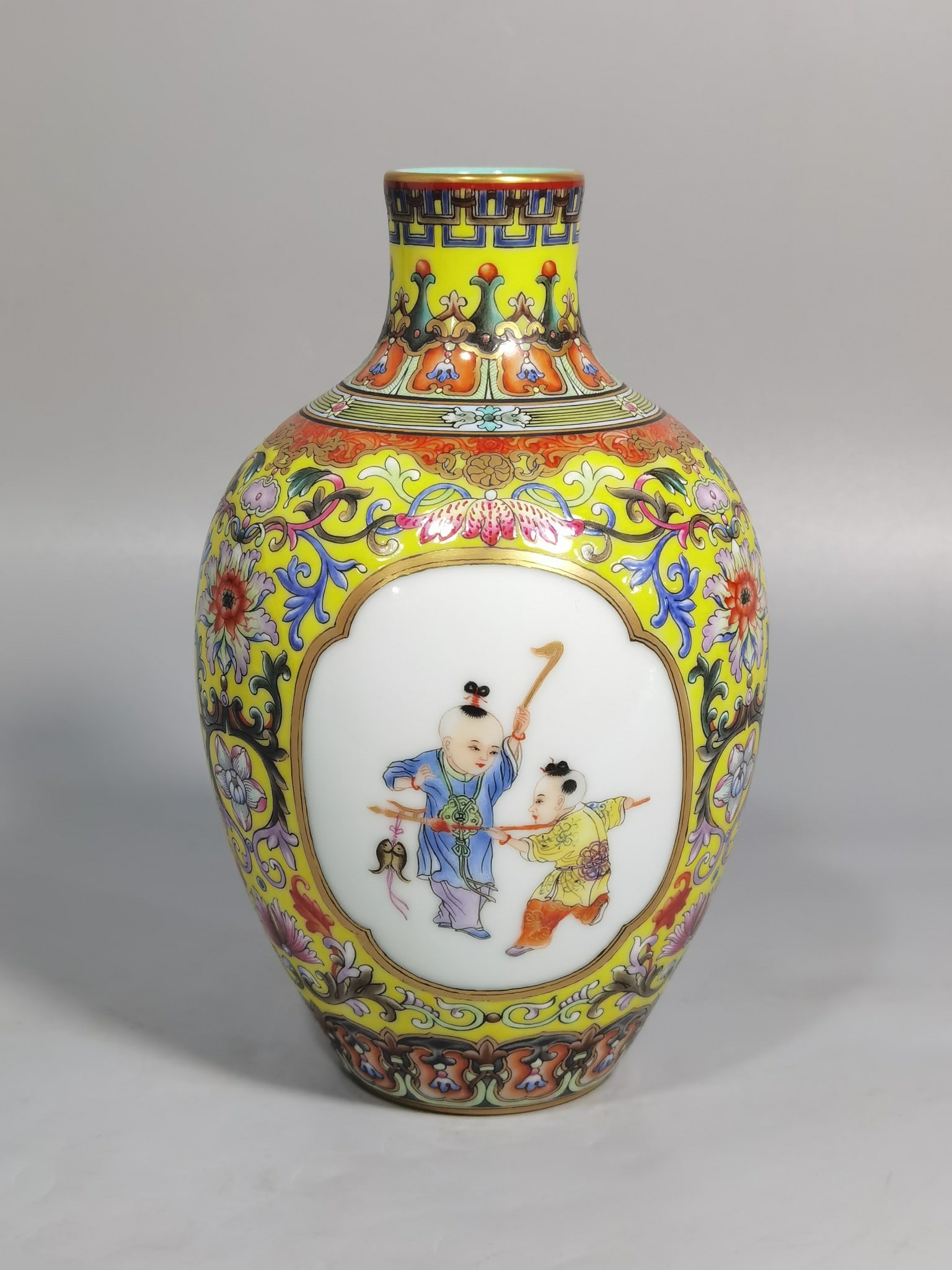 An Exquisite Chinese enamel yellow ground consecrated baby play vase: Size: Height 16.3 cm - Width 10 cm |Materials: Porcelain |Style Dynasty: Qing dynasty |Inscription: Qianlong Mark |Object: vase