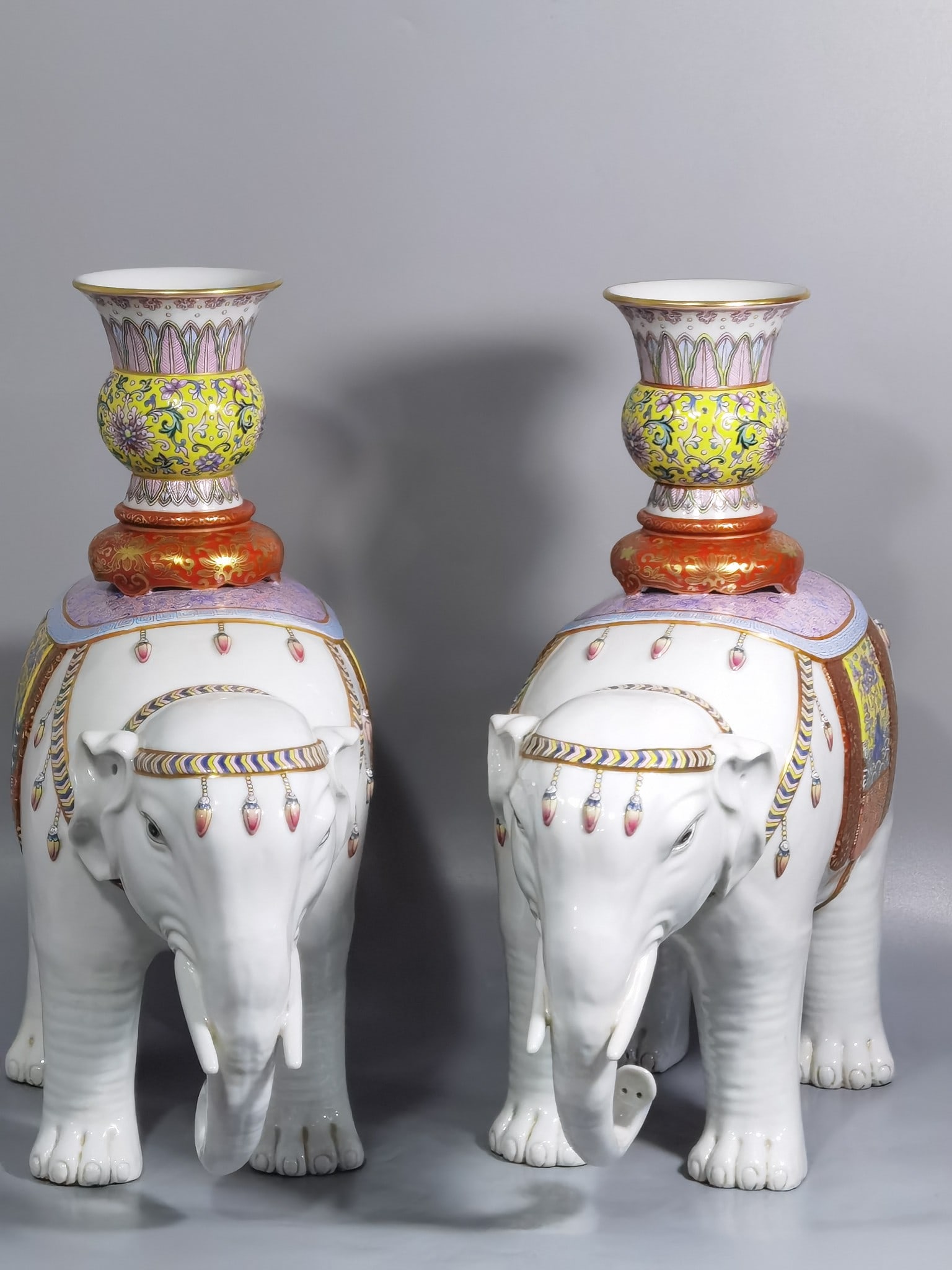 An Exquisite Chinese a pair of pastel gold-painted Taiping elephants: Size: Height 33.5 cm - Width 33 cm |Materials: Porcelain |Style Dynasty: Qing dynasty |Inscription: Qianlong Mark |Object: statue
