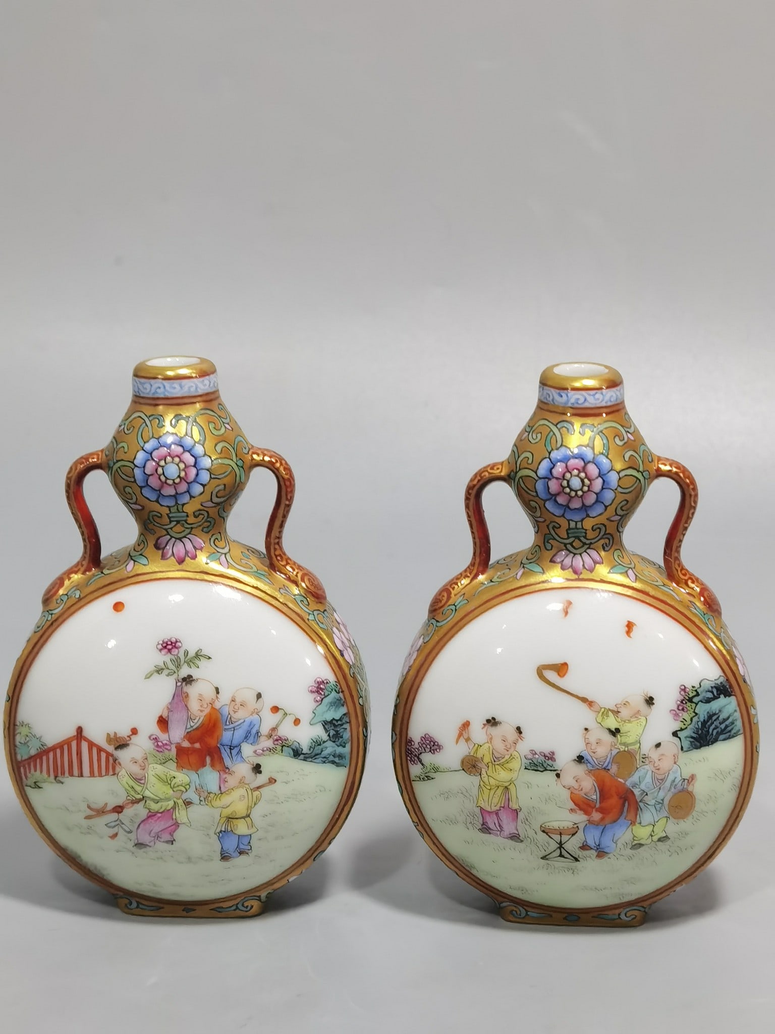 An Exquisite Chinese a gold-colored pastel window-opening baby's play figure with a small ribbon and: Size: Height 9 cm - Width 5.8 cm |Materials: Porcelain |Style Dynasty: Qing dynasty |Inscription: Qianlong Mark |Object: vase