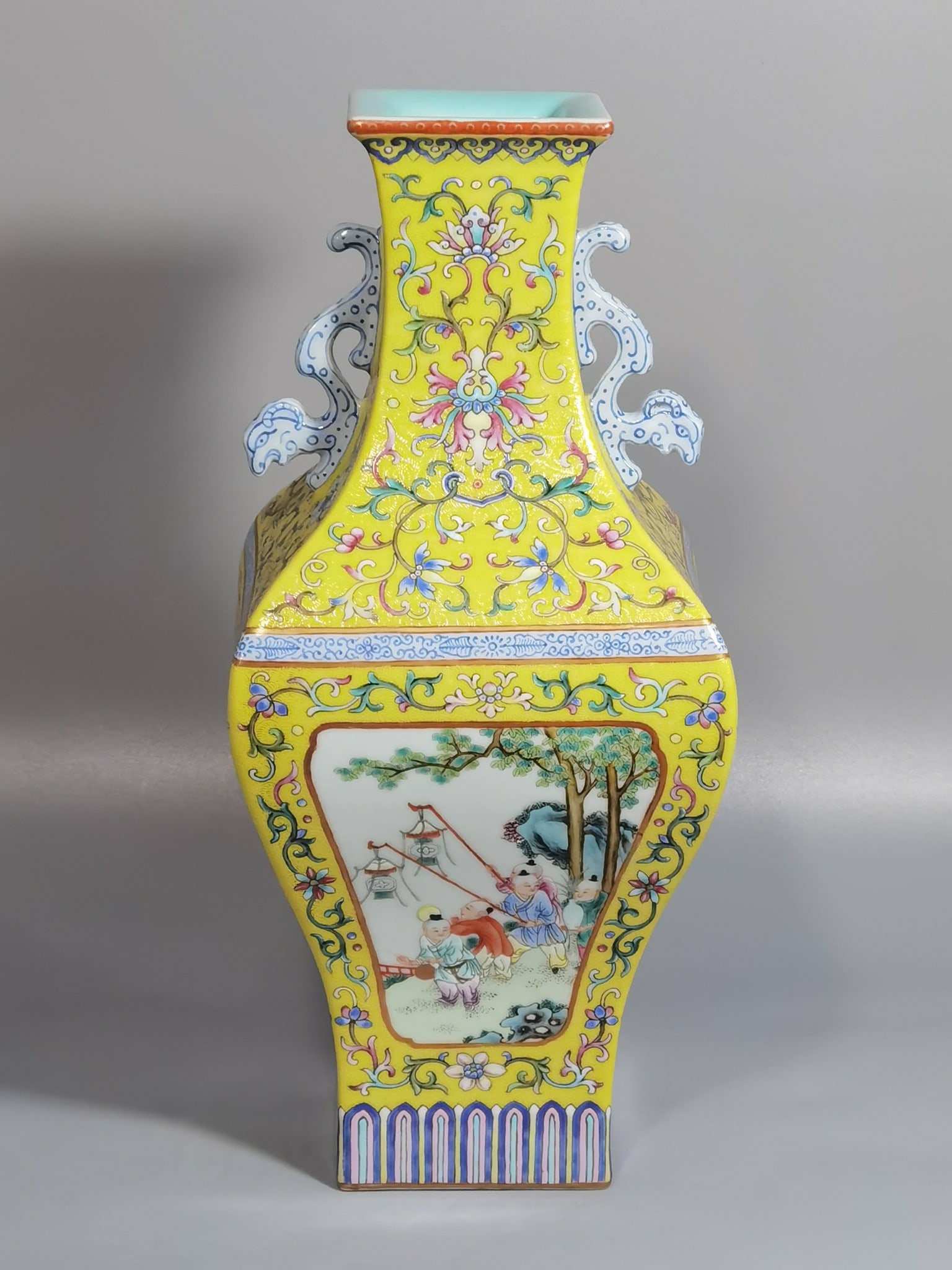 An Exquisite Chinese a yellow ground rolling road and pastel windowed boy's double-eared square vase: Size: Height 30.5 cm - Width 14 cm |Materials: Porcelain |Style Dynasty: Qing dynasty |Inscription: Qianlong Mark |Object: vase
