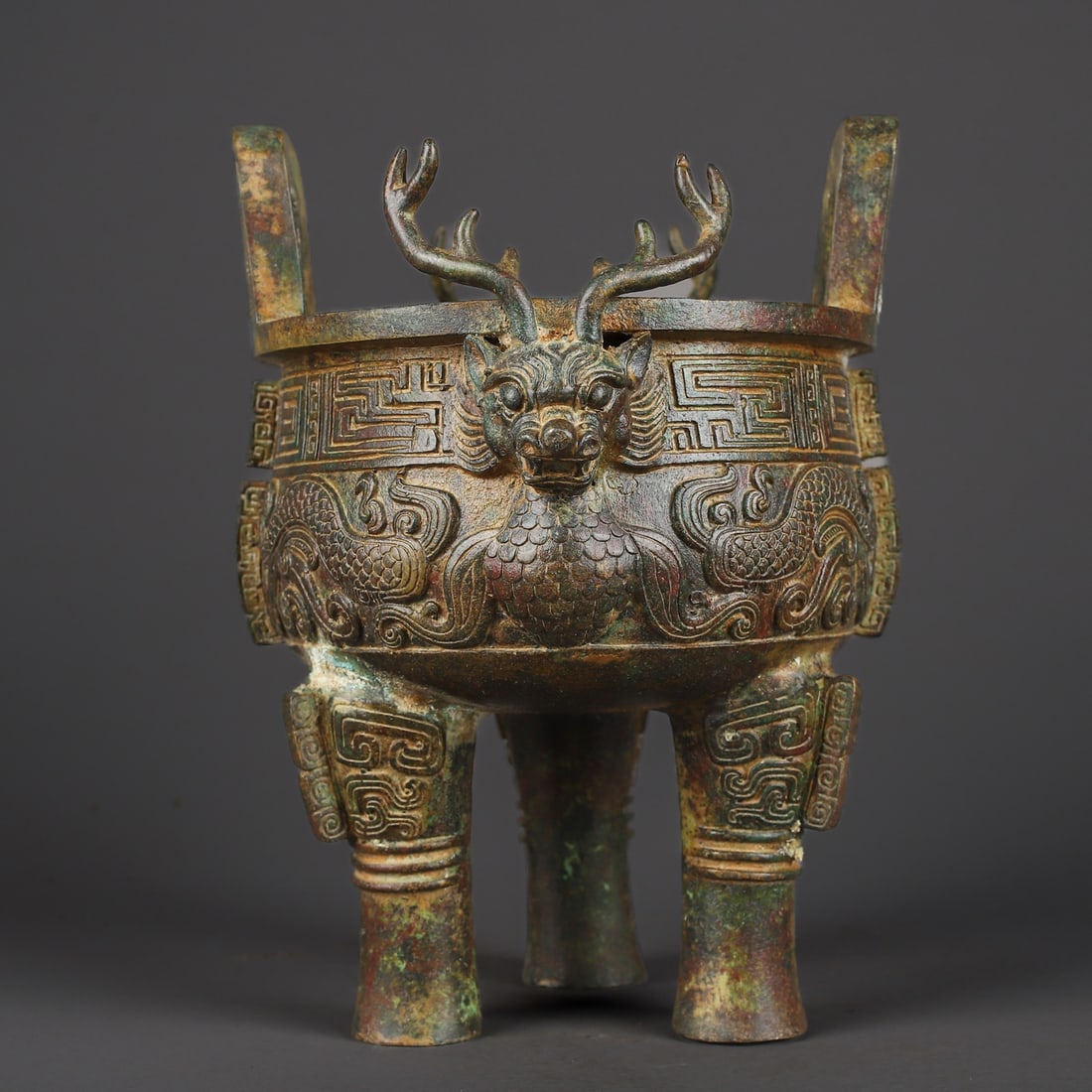 An Exquisite Chinese Bronze Dragon Head Round Tripod: Size: Height 24 cm - Width 21 cm |Materials: Bronze |Dynasty: zhou dynasty |Attribution: 700-BC |Object: Bell