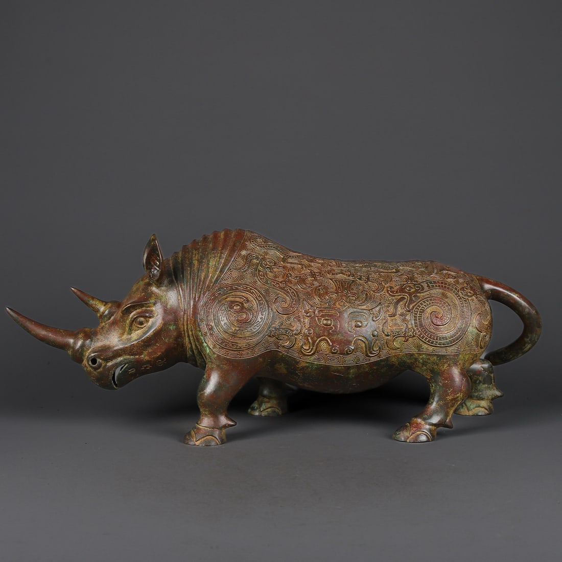 An Exquisite Chinese Bronze Mangong Rhinoceros Statue: Size: Height 19 cm - Width 47 cm |Materials: Bronze |Dynasty: zhou dynasty |Attribution: 700-BC |Object: Bell