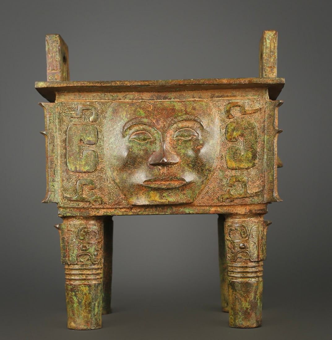 An Exquisite Chinese Bronze human faced square tripod: Size: Height 35 cm - Width 28.6 cm Materials: Bronze Dynasty: zhou dynasty Attribution: 700-BC Object: Bell