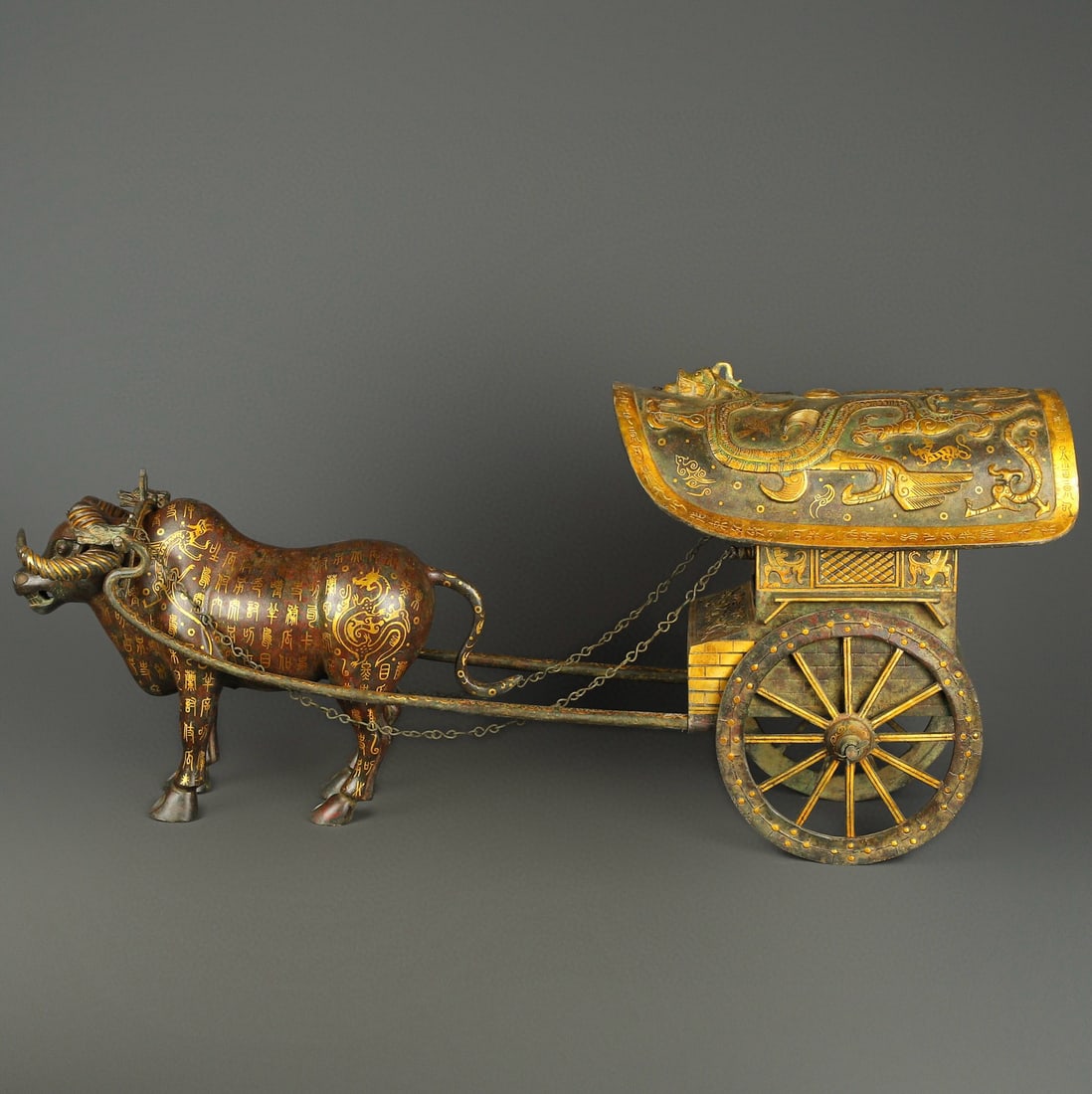 An Exquisite Chinese Bronze and gold ox drawn cart: Size: Height 42 cm - Width 92 cm Materials: Bronze Dynasty: Han dynasty Attribution: 1st to 3rd-C Object: Bell