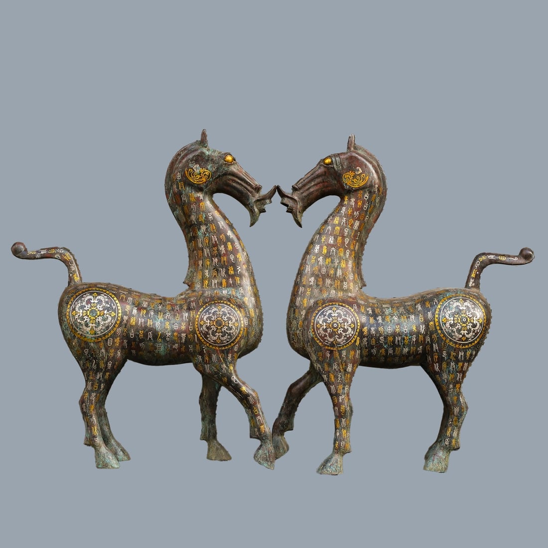An Exquisite Chinese A pair of bronze and gold and silver horses: Size: Height 76 cm - Width 60 cm Materials: Bronze Dynasty: Han dynasty Attribution: 1st to 3rd-C Object: Bell
