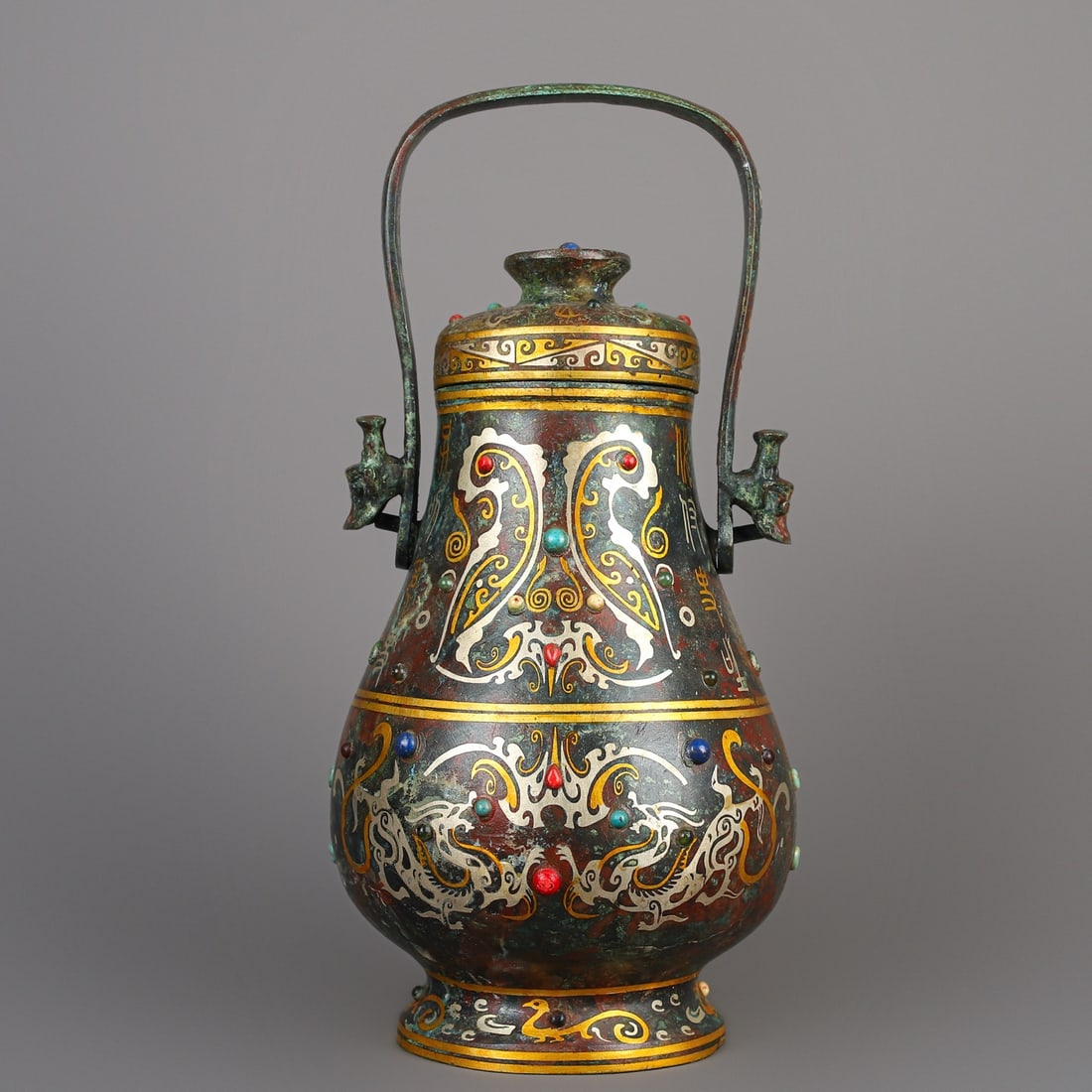 An Exquisite Chinese Bronze and gold inlaid animal head lifting beam: Size: Height 30 cm - Width 16 cm Materials: Bronze Dynasty: Han dynasty Attribution: 1st to 3rd-C Object: Bell