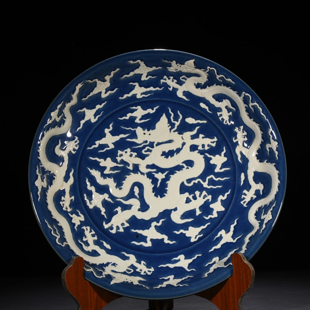 An Exquisite Chinese Blue Glaze Carved Dragon Plate: Size: Height 6 cm - Widthh 45 cm Materials: Porcelain Dynasty: Ming Dynasty Attribution: Xuande Mark Object: plate