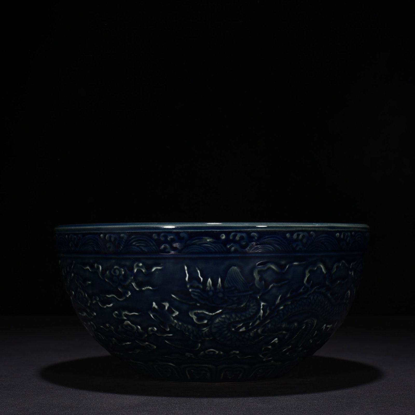 An Exquisite Chinese blue glaze carved dragon bowl: Size: Height 13 cm - Widthh 27 cm Materials: Porcelain Dynasty: Ming Dynasty Attribution: Xuande Mark Object: bowl