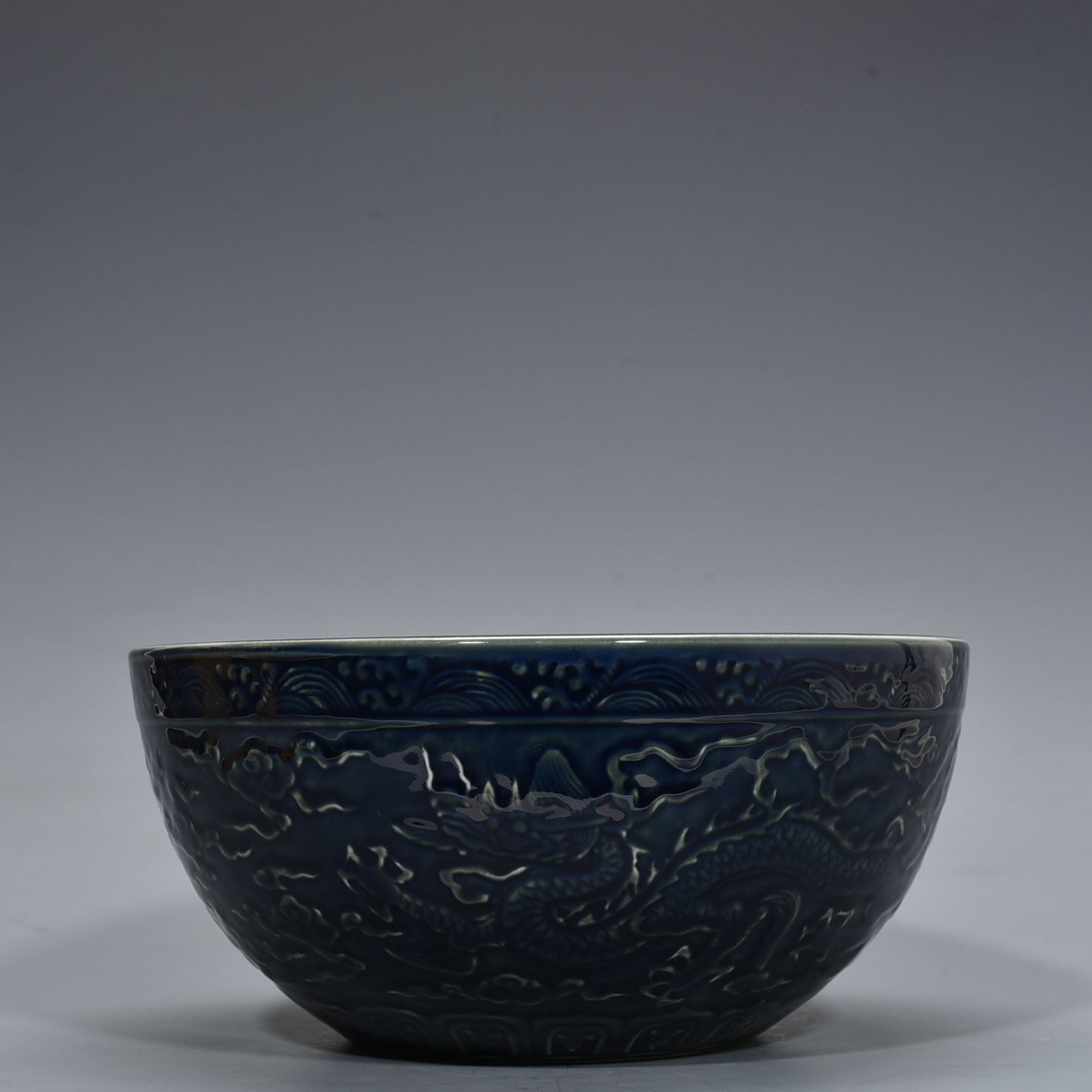 An Exquisite Chinese blue-glazed dragon-patterned bowl: Size: Height 12 cm - Widthh 27 cm Materials: Porcelain Dynasty: Ming Dynasty Attribution: Xuande Mark Object: bowl