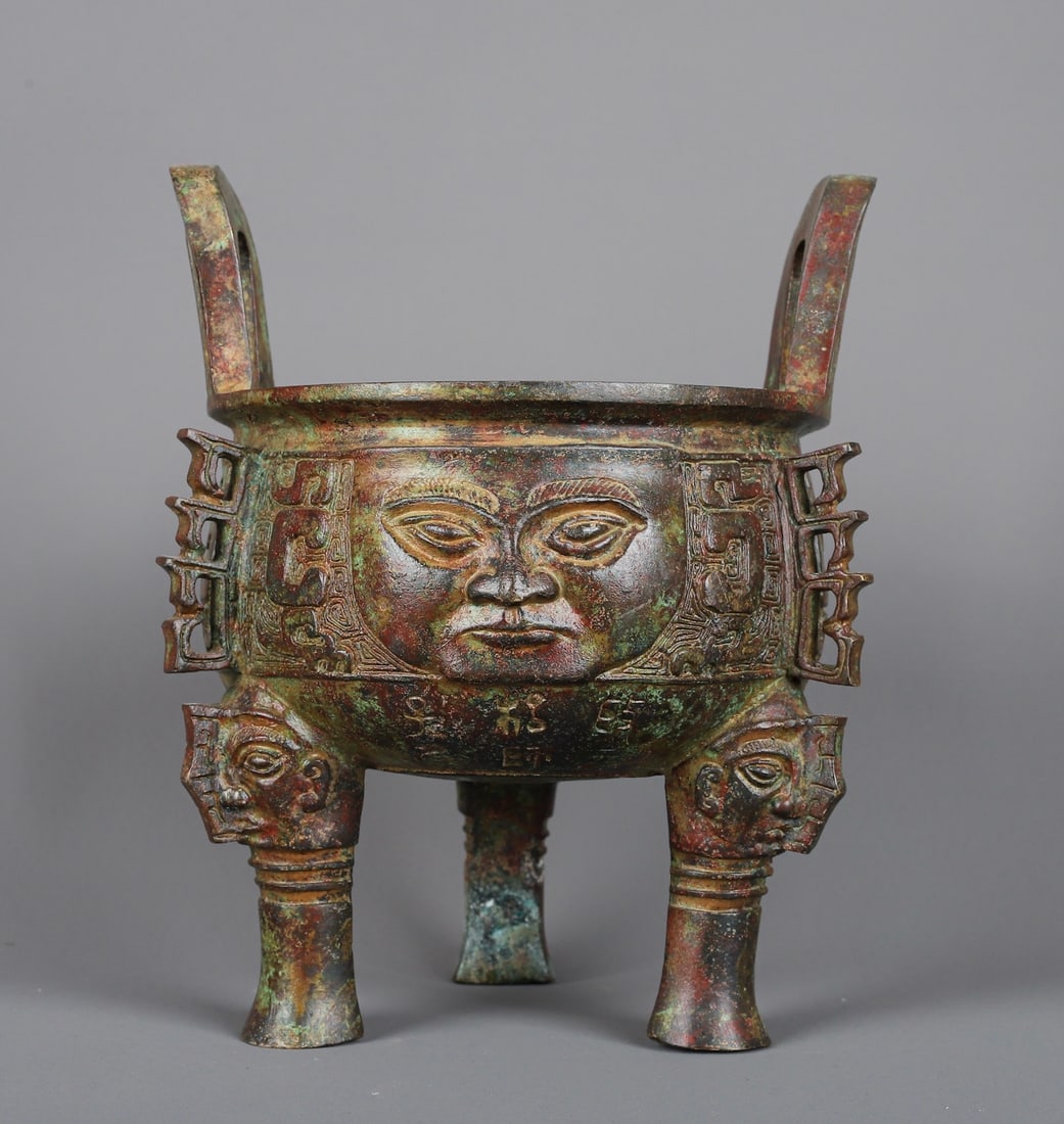 An Exquisite Chinese Bronze human faced round tripod: Size: Height 22 cm - Width 18 cm Materials: Bronze Dynasty: zhou dynasty Attribution: 700-BC Object: Chinese Antiques
