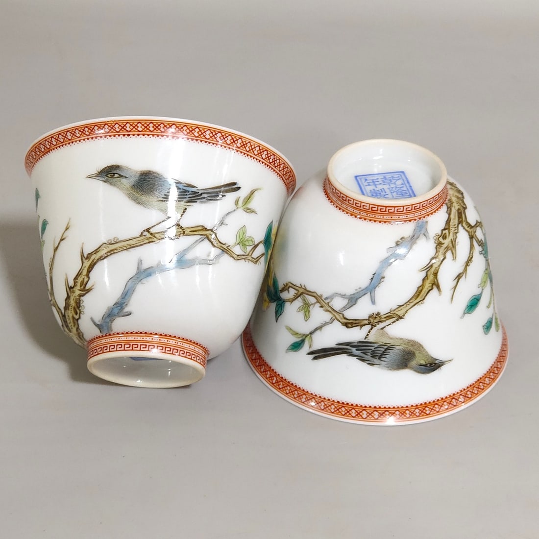 An Exquisite Chinese enamel cup with flowersAnd birds inscribed with poems: Size: Width 6.7 cm - Height 4.9 cm Materials: Porcelain Dynasty: Qing dynasty Inscription: Qianlong Mark Object: cup