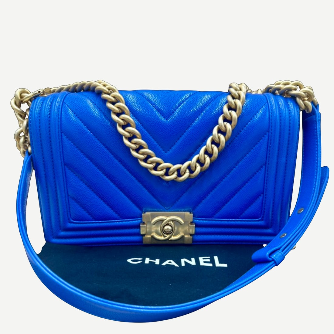 CHANEL Boy Bag, Medium, Blue Chevron Quilted Calfskin, Gold Hardware: Introduced in 2011, the Chanel Boy Bag has become one of the House's defining contemporary handbag designs. Inspired by structured lines and a modern aesthetic, it offers a distinctive interpretation 