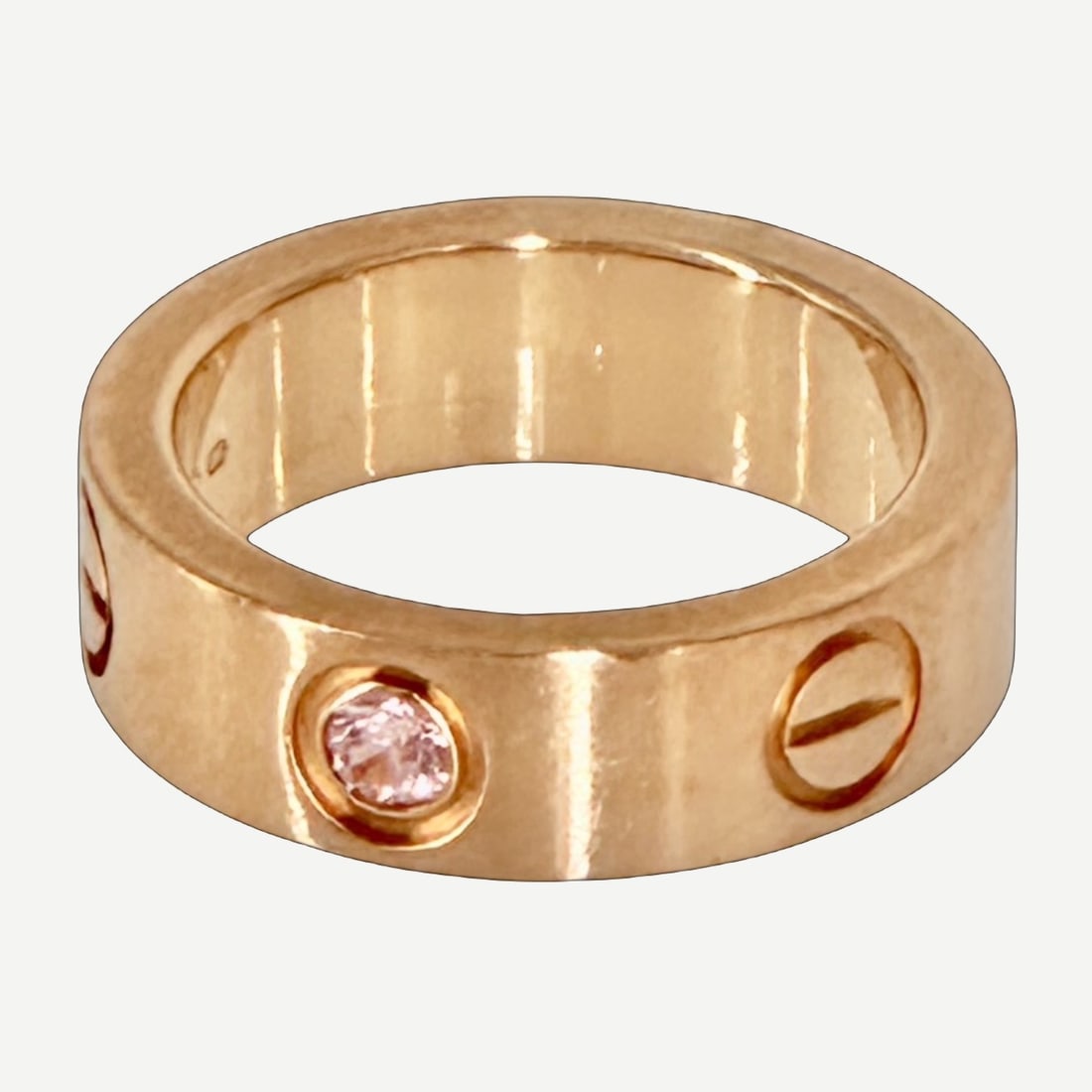 CARTIER Love Ring, Vintage Classic Model, Pink Sapphire, 18K Rose Gold, EU Size 47 (US 4): A classic Cartier Love Ring in warm rose gold, accented by a vibrant pink sapphire and defined by the Maison's signature screw motif. Offered in EU size 47, approximately US size 4, this example refle