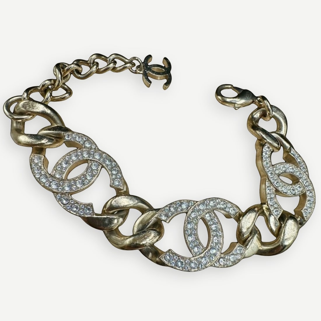 CHANEL CC Link Bracelet, Crystal Embellished, Gold-Tone, 9 in.: A captivating piece of Chanel costume jewelry, this CC Link Bracelet features alternating polished gold-tone curb links and crystal-embellished interlocking CC motifs. Balancing bold design with refin