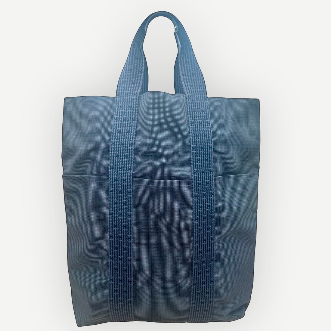 HERMES Herline Cabas MM Canvas Tote Bag: A timeless Hermes Herline Cabas MM tote crafted in durable gray canvas and accented with the collectionÕs signature woven H-pattern web handles. Celebrated for its minimalist design and exceptional f