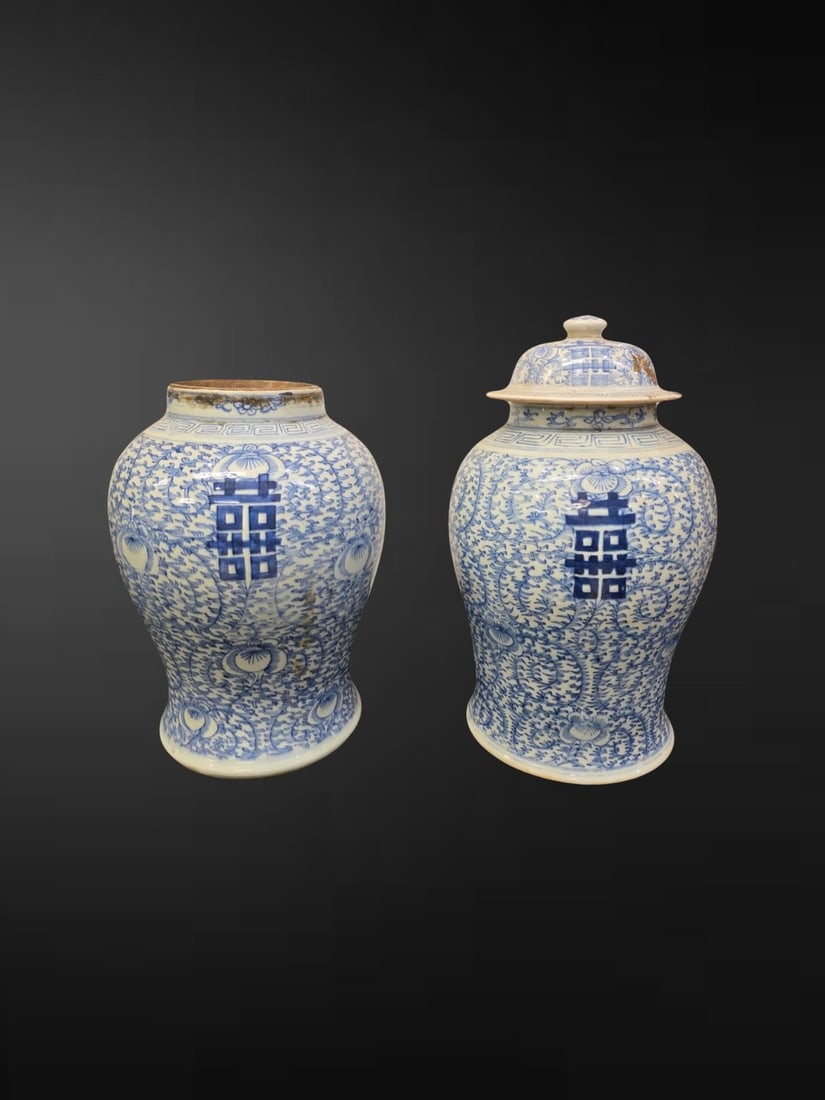 Pair of Chinese Blue and White ‘Double Happiness’ Baluster Jars: A pair of Chinese blue and white baluster jars of the type traditionally commissioned for weddings, each of robust ovoid form rising from a slightly spreading foot to a waisted neck, one jar retaining
