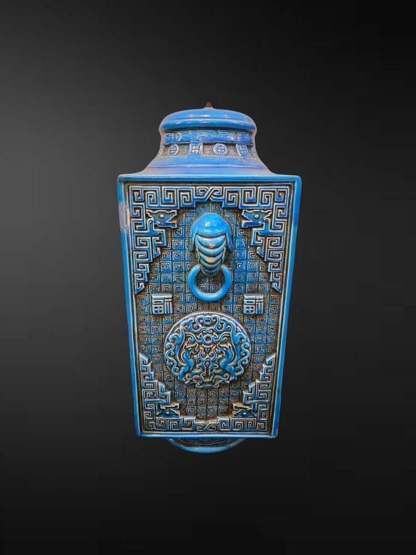 A Large Turquoise-Glazed Archaistic Pottery Vase and Cover: An imposing square-sectioned vase and domed cover of tapering archaistic form, the moulded earthenware body covered overall in a vivid turquoise-blue glaze pooling over crisply worked relief decoratio