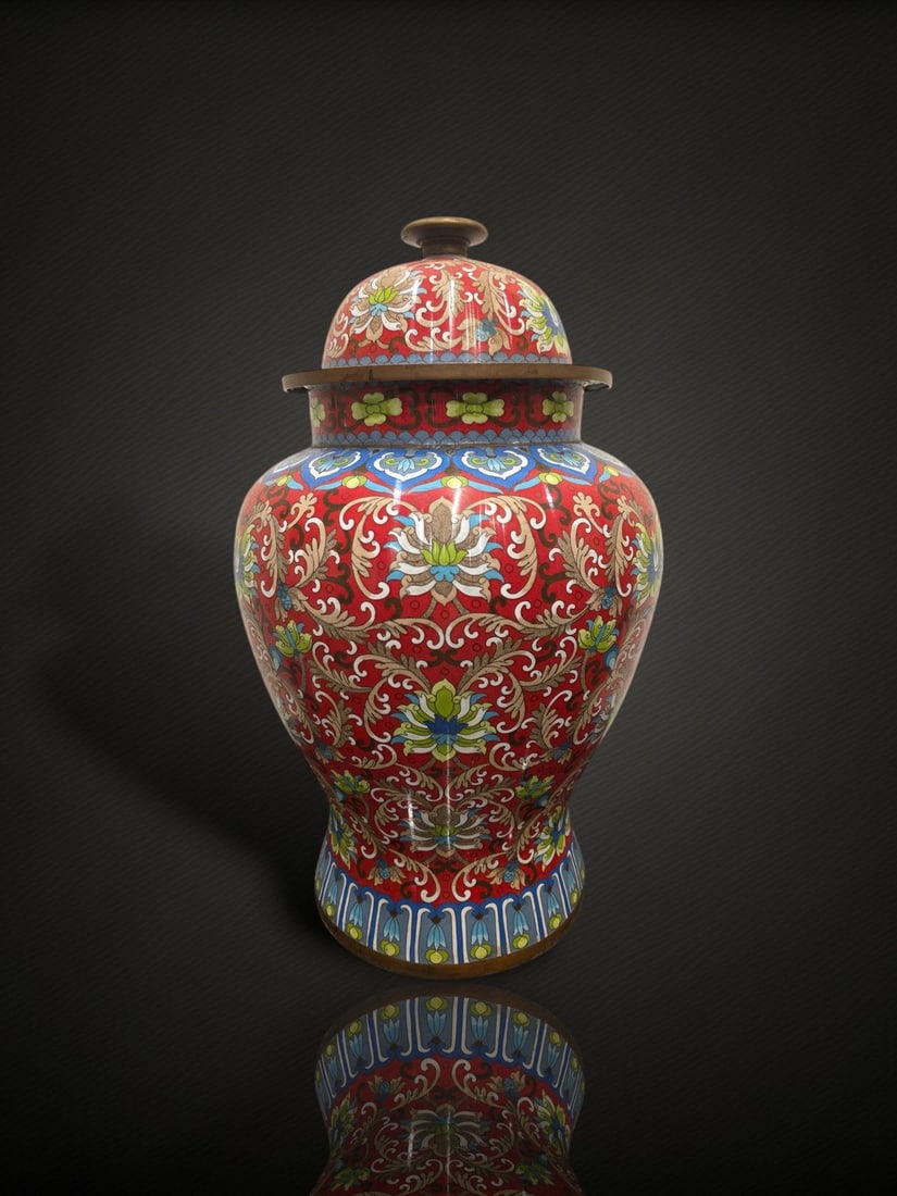 A Chinese Cloisonné Enamel 'Lotus Scroll' Covered Jar: A covered baluster jar worked in cloisonné enamel, with a high-shouldered body and a domed cover surmounted by a gilt-metal bud finial. The body and cover are decorated overall with dense scrolling l