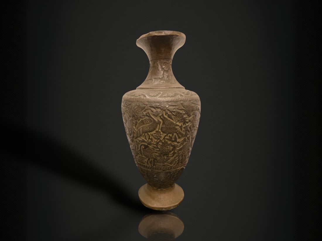 A Chinese Bronze 'Birds and Flowers' Baluster Vase: A tall baluster-form vase of yellow metal, apparently brass or bronze, worked in dense low-relief chasing and repoussé. The waisted neck flares to a trumpet mouth and rises above a broad rounded shou