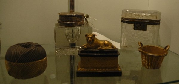 A GROUP OF DESK ARTICLES: COMPRISING A RESTAURATION GILT AND PATINATED BRONZE SMALL INKWELL WITH A LION, INTERIOR LACKING ONE SHAKER, GILT METAL BASKET, MEXICAN GILT STERLING SILVER BOX, IN THE FORM OF A BALL OF STRING