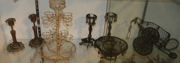A GROUP OF WIREWORK ARTICLES: CANDLESTICKS, EGG HOLDER, BASKET AND TAZZA WITH ADDITIONAL ITEMS