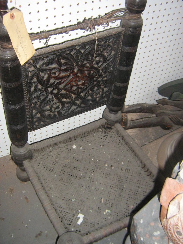 A MIDDLE EASTERN LEATHER & WOOD LOW CHAIR AND: AND MID 19TH CENTURY CARVED TEAKWOOD AND WOVEN SEAT LOW BENCH