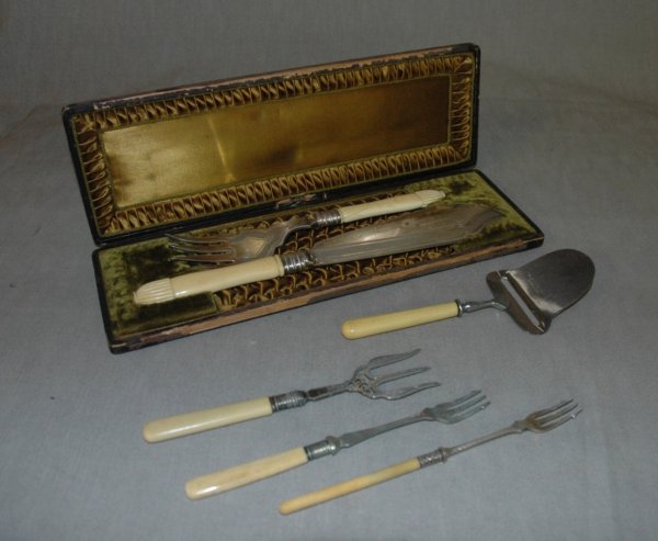 A GROUP OF BONE HANDLED SERVING PIECES, 19th Centur: A GROUP OF BONE HANDLED SERVING PIECES, 19th Century, including a fish server set in box, a knife with three forks and cheese plane and a silver and bone handle fork, largest 12".