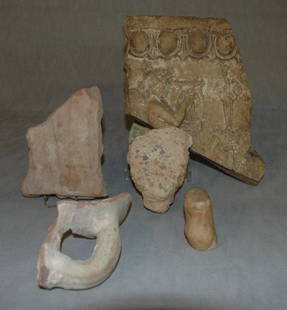 A GROUP OF STONE/POTTERY FRAGMENTS, including an an: A GROUP OF STONE/POTTERY FRAGMENTS, including an ancient Roman relief cut fragment - 1st-2nd Century AD with egg and dart band above profile of a girl playing lyre 10" x 8", one drapery fragment, 4 1/