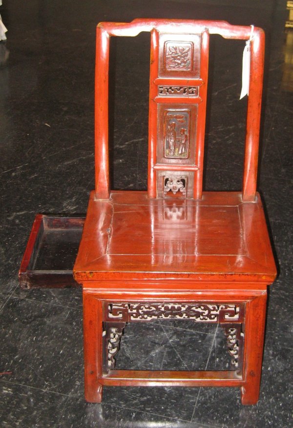 A CHINESE RED LACQUER FOOT BINDING CHAIR with draw: A CHINESE RED LACQUER FOOT BINDING CHAIR with drawer to hold bindings, needles and thread and other implements, C. 1910 Height 33", length 16 1/2", width 13". For similar examples, see Glenn Roberts a
