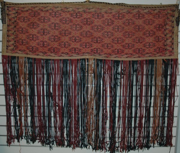 A TURKOMAN BROCADED BAG,19th Century, warp-face wo: A TURKOMAN BROCADED BAG,19th Century, warp-face woven, an example of the art of Turkoman flat weaving. Height 14 1/2", length 46 3/4", fringe, 24" long