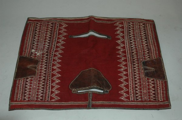 A TUNISIAN, OUDREF SADDLE BLANKET, 20th Century, w: A TUNISIAN, OUDREF SADDLE BLANKET, 20th Century, wool, cotton, and leather. This saddle blanket (bost), was made in Ouref, an oasis near the Tunisian city of Gabes, In contrast to Moroccan saddle cove