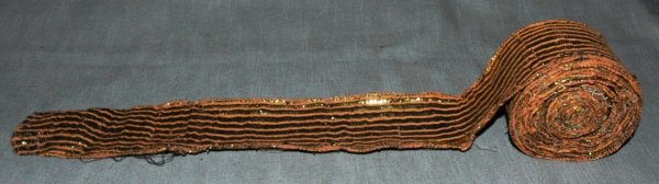A LARGE ROLL OF 1920's GOLD TINSEL BAND.: A LARGE ROLL OF 1920's GOLD TINSEL BAND.
