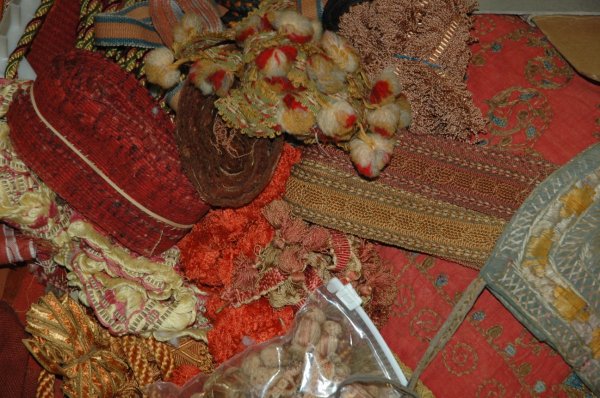 A GROUP OF PASSEMENTERIE TRIMMINGS, 17th Century : A GROUP OF PASSEMENTERIE TRIMMINGS, 17th Century and later, various types of ribbon and fringing, including an embroidered mirror cover, jute embroidery, pillows and a small embroidered bag.